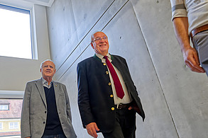 Bezirkstagspräsident Franz Löffler (re.) und sein Stellvertreter Lothar Höher beim Rundgang durch die künftige klinikeigene Kletterhalle – ein zentrales Element des bewegungstherapeutischen Konzepts der neuen Kinder- und Jugendpsychiatrie in Weiden. (c) medbo KU – Johannes Müller