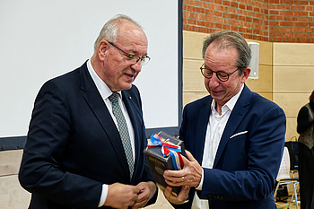 Bezirkstagspräsident Franz Löffler (li.) überreicht Prof. Dr. Romuald Brunner ein persönliches Abschiedsgeschenk. (c) medbo KU / Johannes Müller