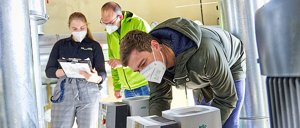 Endspurt im Begehungsmarathon: medbo Klimaschutzmanager Max Winter (vorne) liest Daten der Heizungspumpe am Bezirksklinikum Regensburg ab, während Christian Winterhalter und Elisabeth Hockemeyer von der Energieagentur Regensburg die Werte dokumentieren.