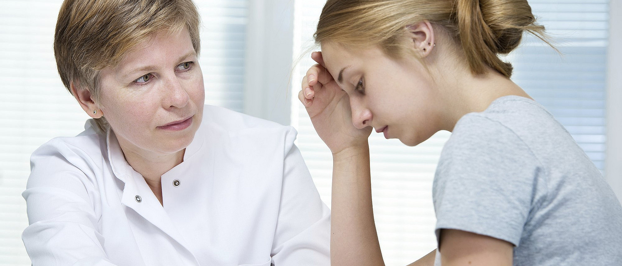 Ärztin und junge Patientin (AlexRaths | iStock)