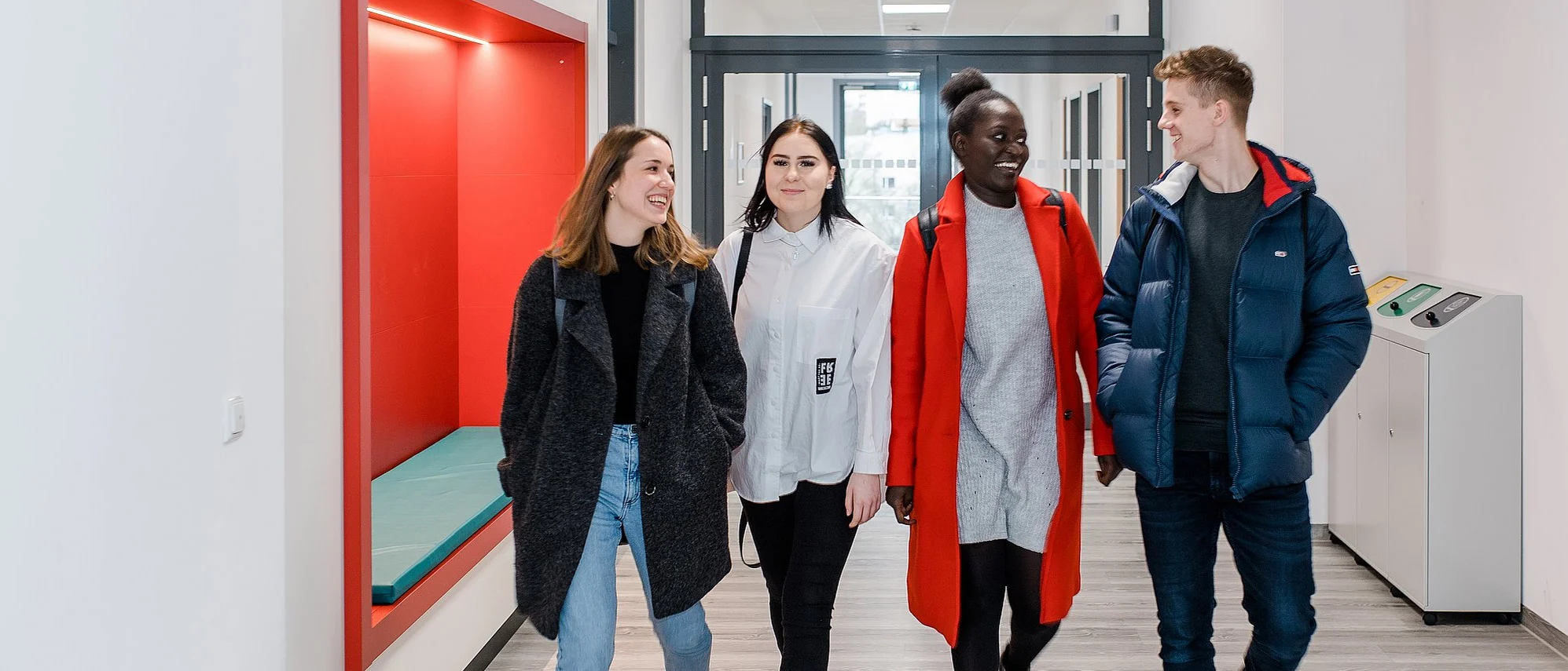 Bild zeigt vier Schüler:innen auf dem Gang in den medbo Pflegeschulen